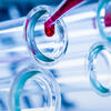 an image of liquid going into a beaker