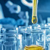 an image of liquid going into a beaker
